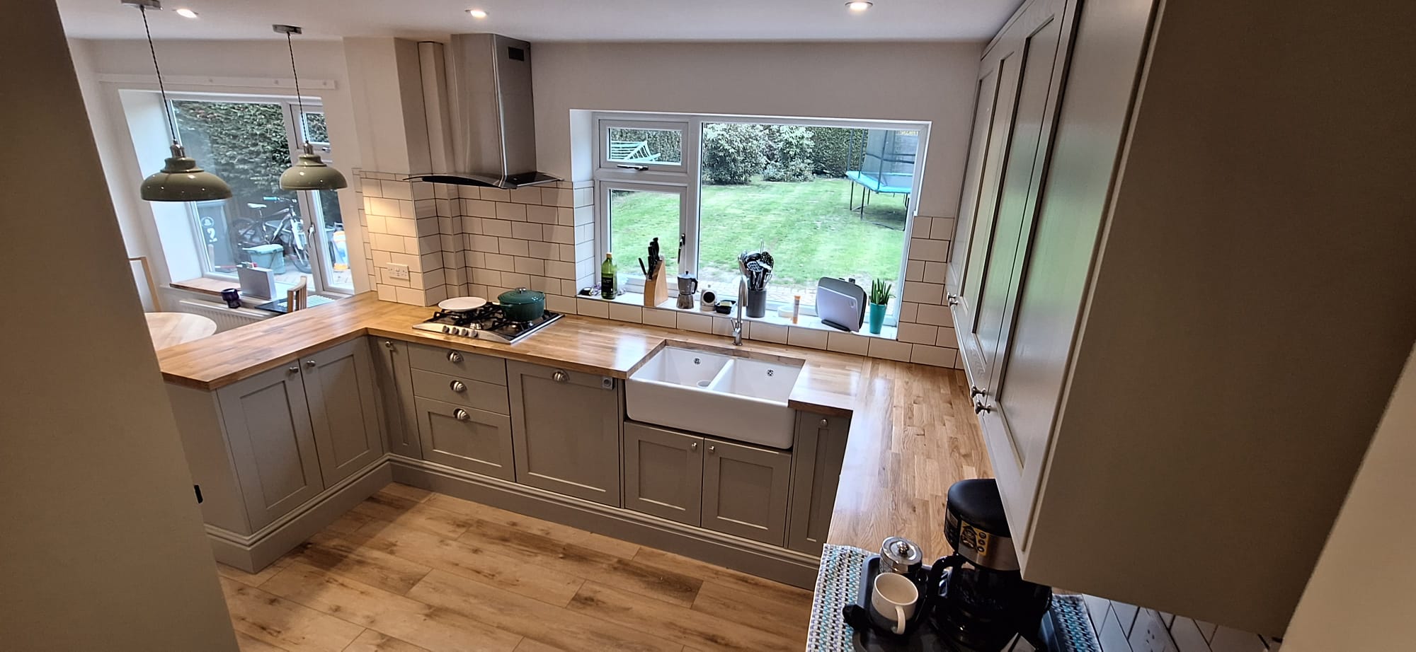 Completed shaker kitchen with oak worktops and garden view