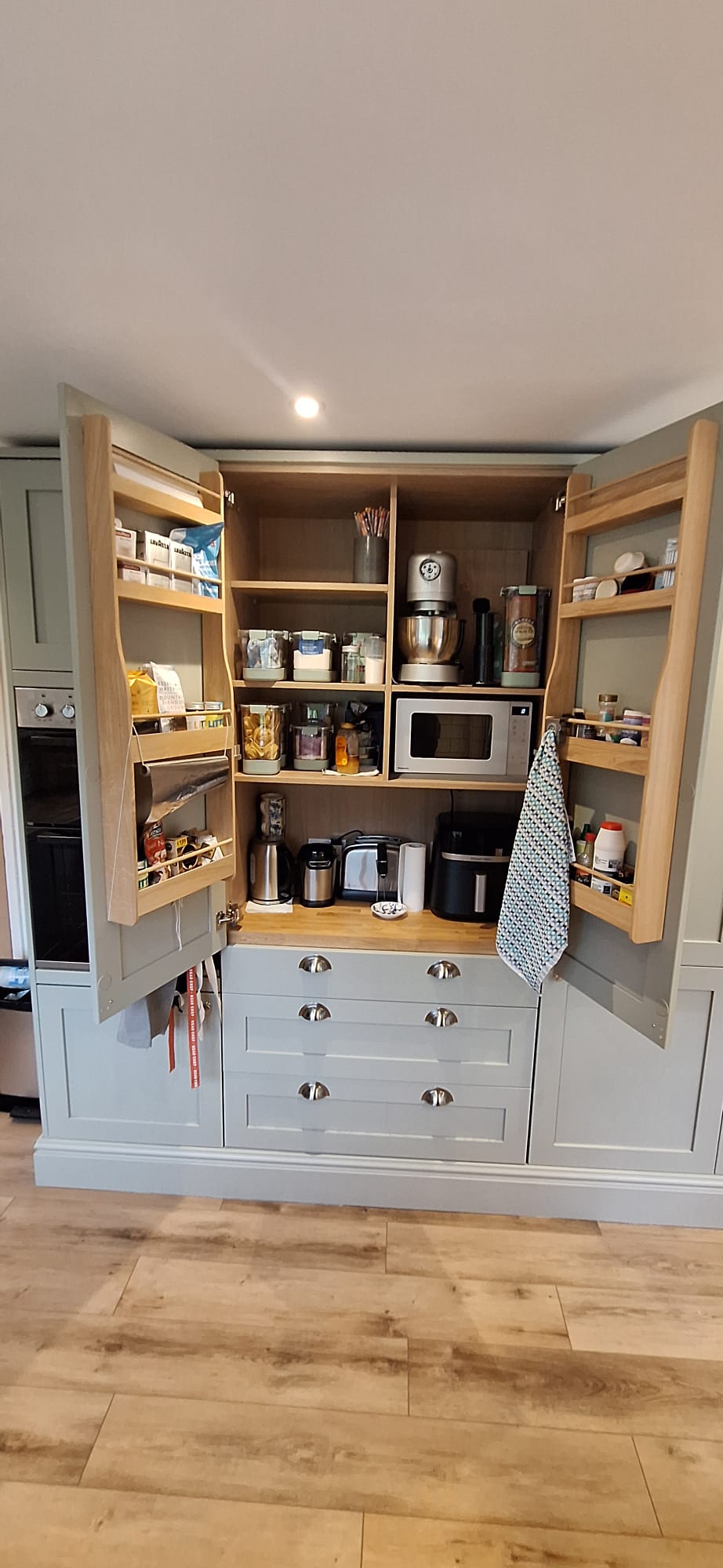 Open fitted pantry showing bespoke internal storage